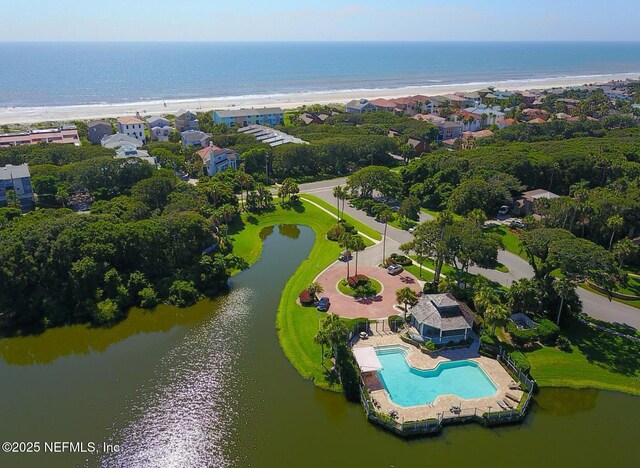 aerial view of a nearby body of water and a pool