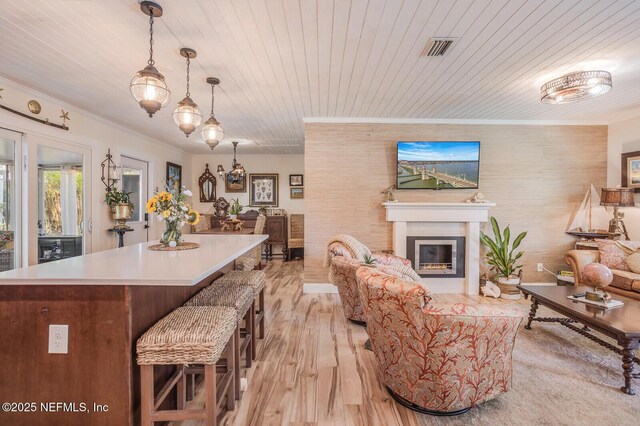 120 Swallow Rd, Saint Augustine, FL 32086 - living area with light wood-type flooring, wood ceiling, a glass covered fireplace, and ornamental molding