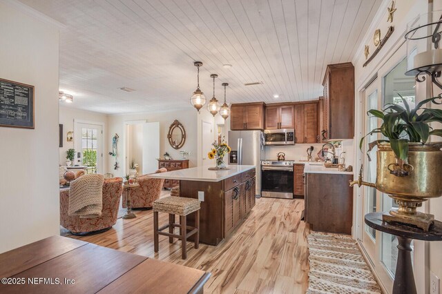 120 Swallow Rd, Saint Augustine, FL 32086 - kitchen featuring stainless steel appliances, light countertops, a breakfast bar, light wood-type flooring, and wood ceiling