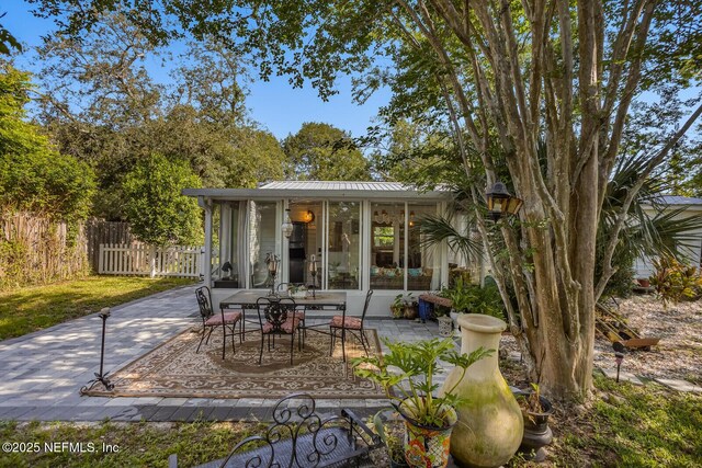 120 Swallow Rd, Saint Augustine, FL 32086 - view of patio / terrace featuring fence, outdoor dining space, and a sunroom
