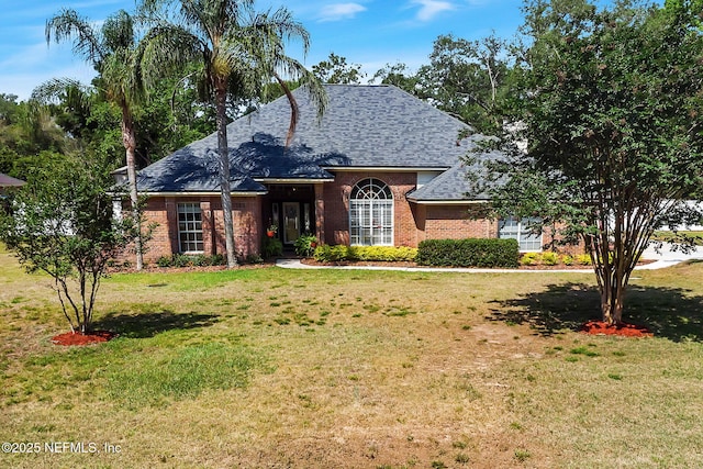 2072 Hawkcrest Dr E, Saint Johns, FL 32259 - view of front of home featuring brick siding, a shingled roof, and a front yard