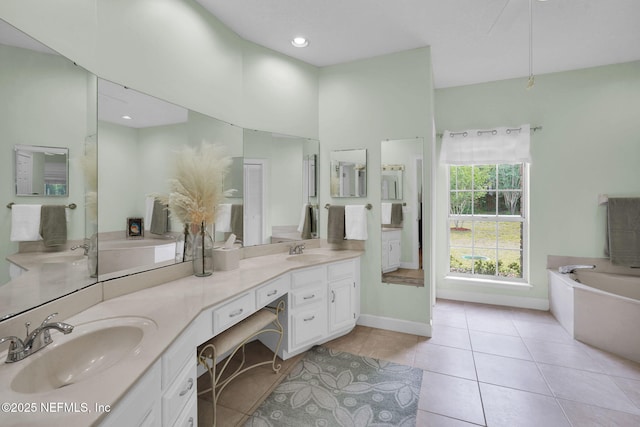 2072 Hawkcrest Dr E, Saint Johns, FL 32259 - full bathroom with double vanity, a bath, tile patterned flooring, and baseboards