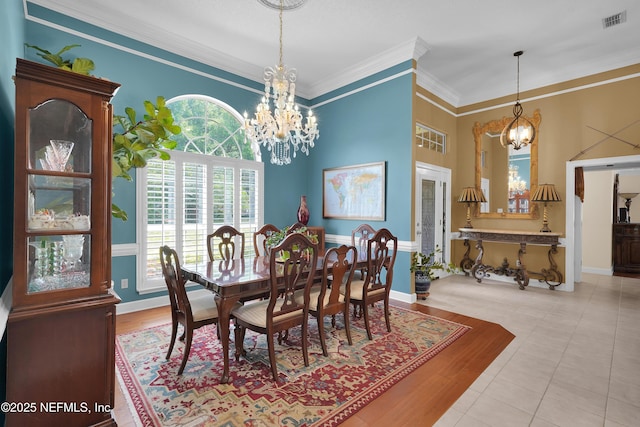 2072 Hawkcrest Dr E, Saint Johns, FL 32259 - dining space with a chandelier, crown molding, a high ceiling, tile patterned floors, and baseboards