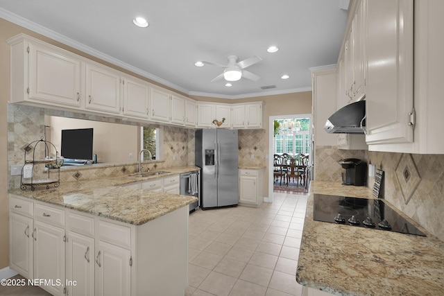 2072 Hawkcrest Dr E, Saint Johns, FL 32259 - kitchen with appliances with stainless steel finishes, range hood, a sink, backsplash, and crown molding
