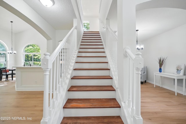 2012 Belle Grove Ter, Fleming Island, FL 32003 - stairs with wood finished floors, a chandelier, healthy amount of natural light, and baseboards