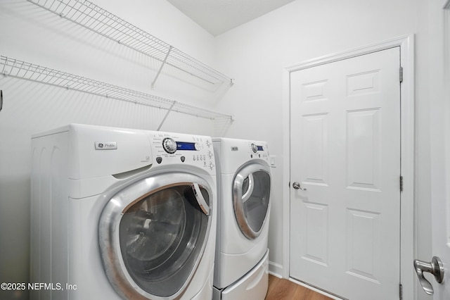 2012 Belle Grove Ter, Fleming Island, FL 32003 - laundry room with separate washer and dryer and wood finished floors