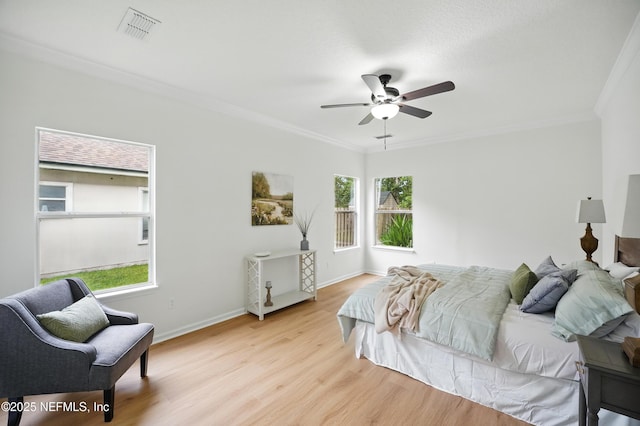 2012 Belle Grove Ter, Fleming Island, FL 32003 - bedroom with multiple windows, crown molding, light wood finished floors, baseboards, and a ceiling fan