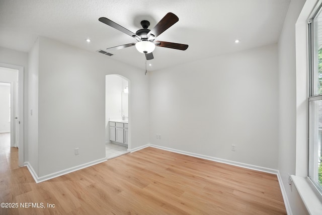 2012 Belle Grove Ter, Fleming Island, FL 32003 - unfurnished room featuring arched walkways, ceiling fan, plenty of natural light, light wood-style flooring, and recessed lighting