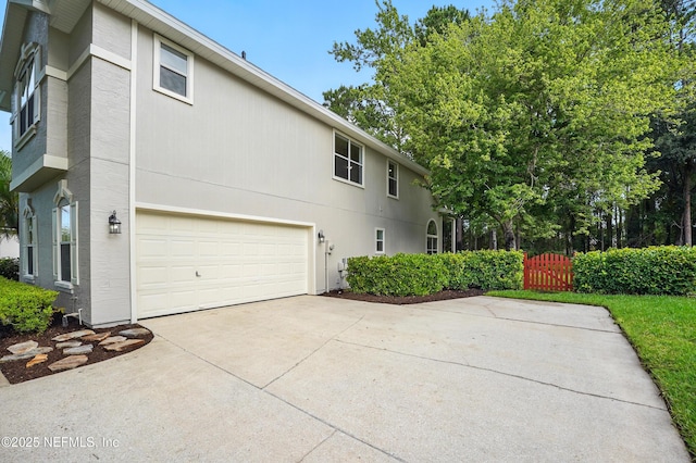 2012 Belle Grove Ter, Fleming Island, FL 32003 - view of side of property with driveway, a garage, and a gate