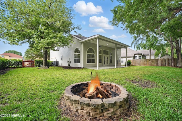 2012 Belle Grove Ter, Fleming Island, FL 32003 - back of house featuring a fire pit, a patio area, central AC, and stucco siding