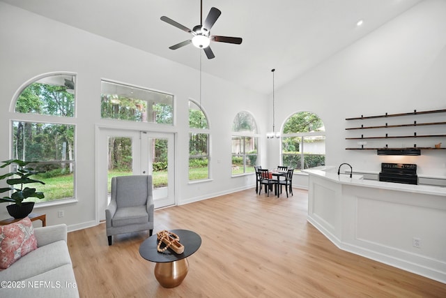 2012 Belle Grove Ter, Fleming Island, FL 32003 - living room featuring light wood-type flooring, plenty of natural light, a ceiling fan, high vaulted ceiling, and french doors