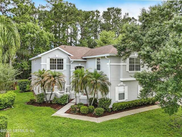 2012 Belle Grove Ter, Fleming Island, FL 32003 - view of front facade with a gate, stucco siding, and a shingled roof