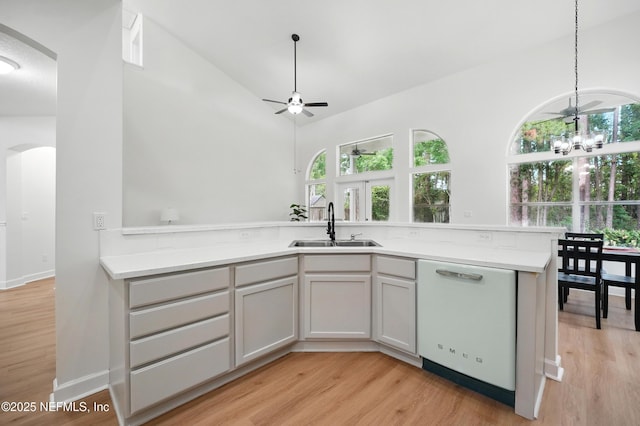 2012 Belle Grove Ter, Fleming Island, FL 32003 - kitchen featuring dishwasher, a sink, light countertops, light wood-style flooring, and vaulted ceiling