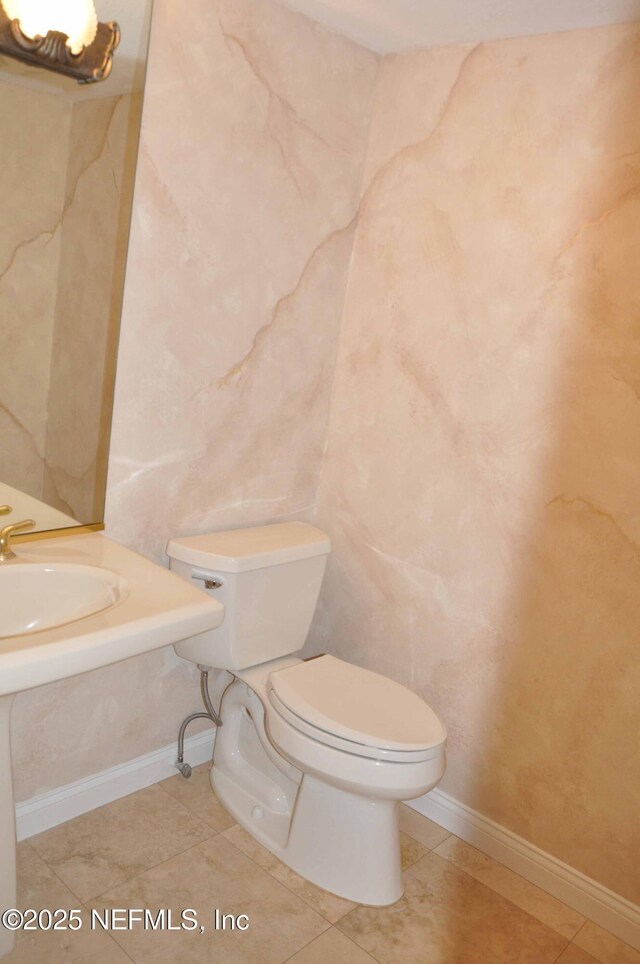 bathroom featuring toilet and tile patterned floors