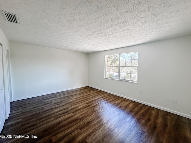 5201 Atlantic Blvd Unit 299, Jacksonville, FL 32207 - unfurnished bedroom featuring dark wood-style flooring, a textured ceiling, and baseboards