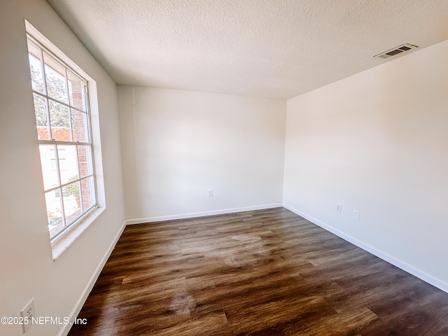 5201 Atlantic Blvd Unit 299, Jacksonville, FL 32207 - unfurnished room with dark wood-style flooring, a textured ceiling, and baseboards