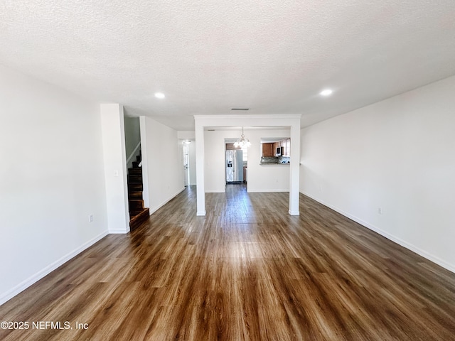 5201 Atlantic Blvd Unit 299, Jacksonville, FL 32207 - unfurnished living room featuring stairs, dark wood finished floors, baseboards, a textured ceiling, and recessed lighting