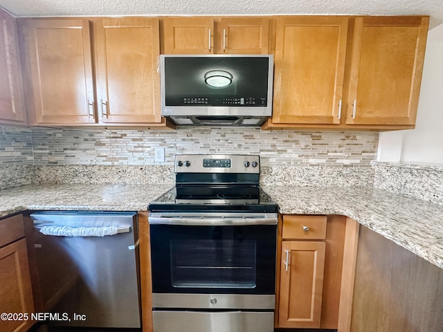 5201 Atlantic Blvd Unit 299, Jacksonville, FL 32207 - kitchen with appliances with stainless steel finishes, decorative backsplash, and light stone countertops