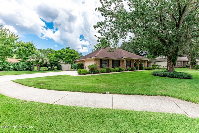 1835 Powder Springs Dr, Jacksonville, FL 32225 - ranch-style home with curved driveway, a front lawn, and brick siding