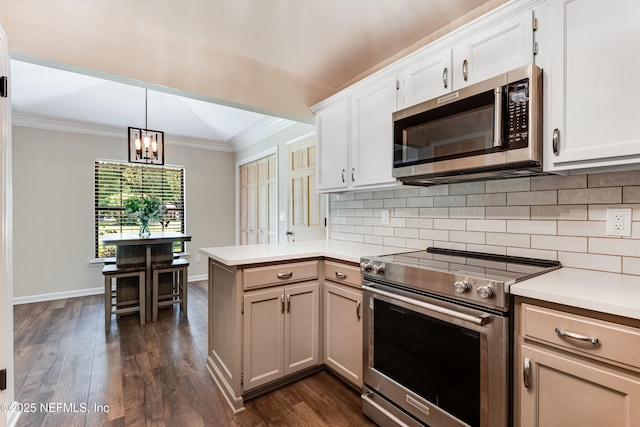 1835 Powder Springs Dr, Jacksonville, FL 32225 - kitchen with stainless steel appliances, a peninsula, ornamental molding, backsplash, and light countertops