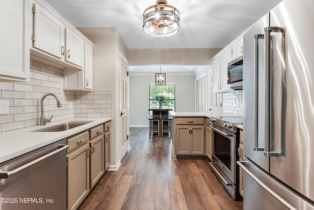 1835 Powder Springs Dr, Jacksonville, FL 32225 - kitchen with high quality appliances, light countertops, dark wood-style floors, decorative backsplash, and a peninsula