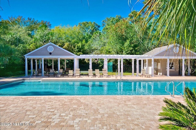 community pool with a gazebo, a patio area, and fence