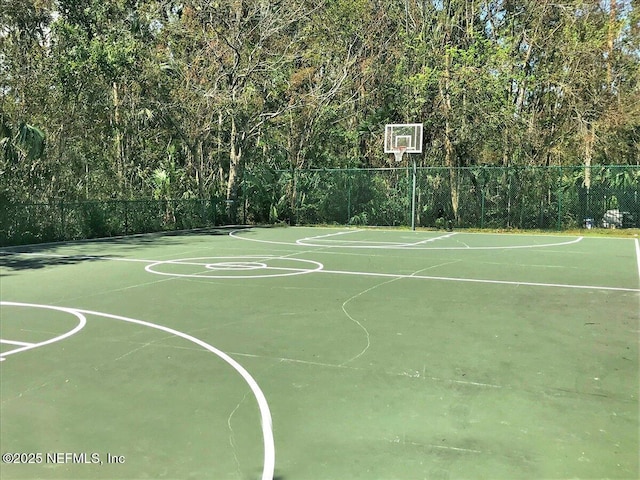 view of basketball court featuring fence and community basketball court