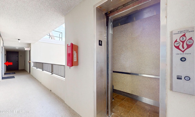 2100 Ocean Dr Unit Ph-2, Jacksonville Beach, FL 32250 - hallway with elevator and a textured ceiling