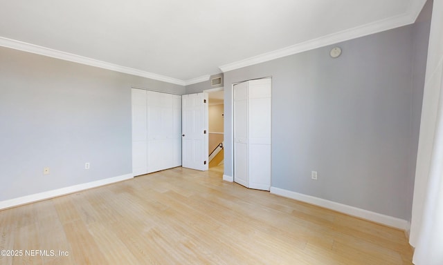 2100 Ocean Dr Unit Ph-2, Jacksonville Beach, FL 32250 - unfurnished bedroom with two closets, light wood-type flooring, and crown molding