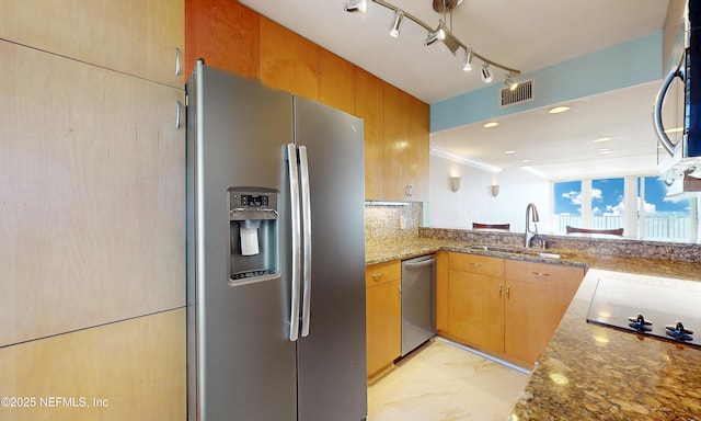2100 Ocean Dr Unit Ph-2, Jacksonville Beach, FL 32250 - kitchen with stainless steel appliances, stone countertops, tasteful backsplash, ornamental molding, and rail lighting