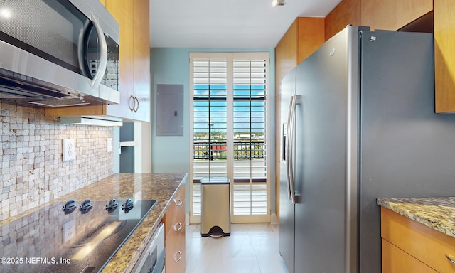 2100 Ocean Dr Unit Ph-2, Jacksonville Beach, FL 32250 - kitchen featuring appliances with stainless steel finishes, electric panel, dark stone counters, backsplash, and brown cabinetry