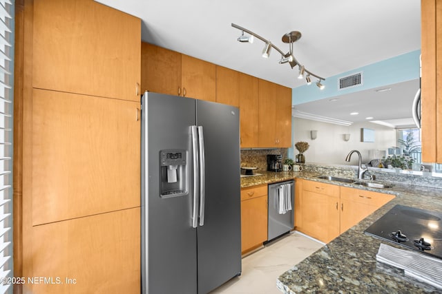 2100 Ocean Dr Unit Ph-2, Jacksonville Beach, FL 32250 - kitchen with appliances with stainless steel finishes, dark stone countertops, rail lighting, light marble finish flooring, and decorative backsplash