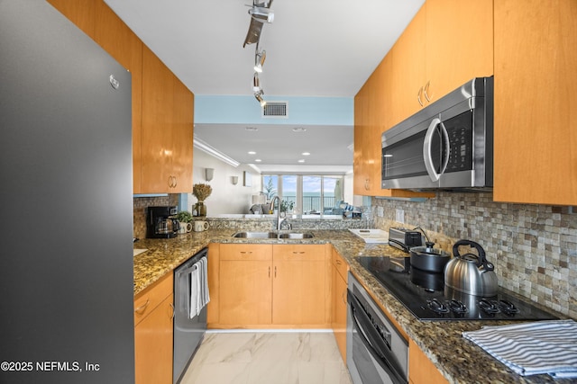 2100 Ocean Dr Unit Ph-2, Jacksonville Beach, FL 32250 - kitchen with appliances with stainless steel finishes, dark stone countertops, decorative backsplash, and light marble finish floors