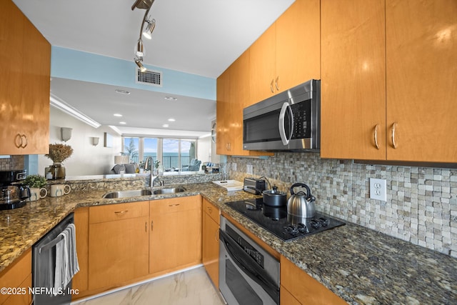 2100 Ocean Dr Unit Ph-2, Jacksonville Beach, FL 32250 - kitchen with appliances with stainless steel finishes, light marble finish floors, dark stone countertops, decorative backsplash, and recessed lighting