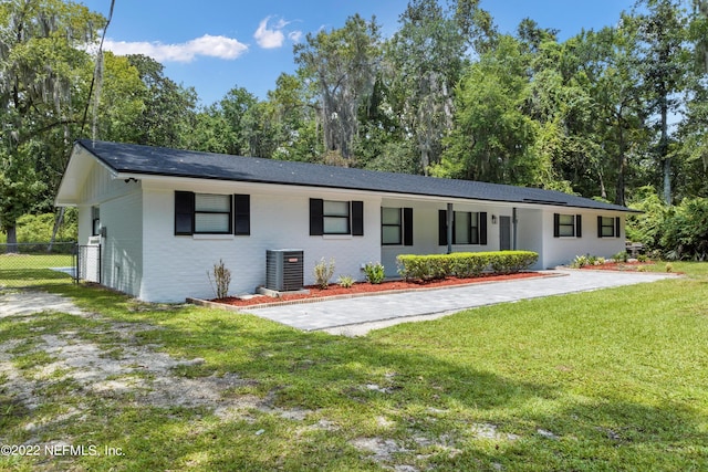 5092 Harvey Grant Rd, Fleming Island, FL 32003 - ranch-style house with central air condition unit, brick siding, and view of scattered trees