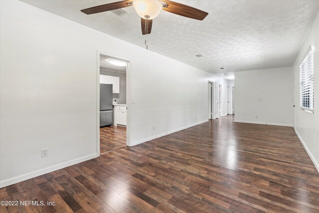 5092 Harvey Grant Rd, Fleming Island, FL 32003 - empty room with ceiling fan, dark wood finished floors, baseboards, and a textured ceiling