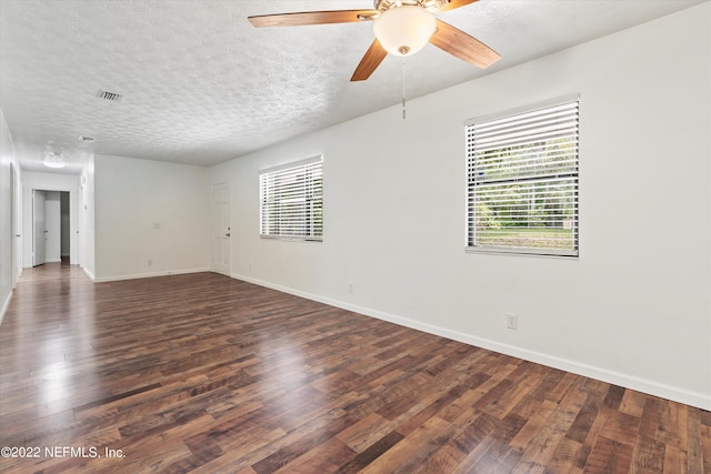 5092 Harvey Grant Rd, Fleming Island, FL 32003 - empty room featuring dark wood-style flooring, a ceiling fan, baseboards, and a textured ceiling