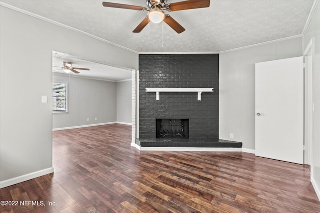 5092 Harvey Grant Rd, Fleming Island, FL 32003 - unfurnished living room with a ceiling fan, wood finished floors, a textured ceiling, a brick fireplace, and crown molding
