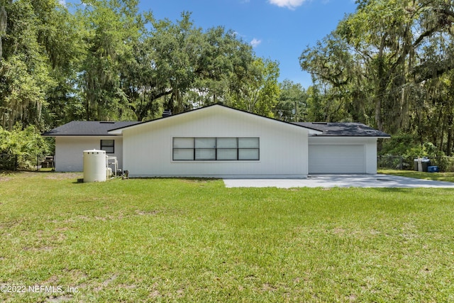5092 Harvey Grant Rd, Fleming Island, FL 32003 - view of property exterior with an attached garage, a yard, driveway, and view of wooded area