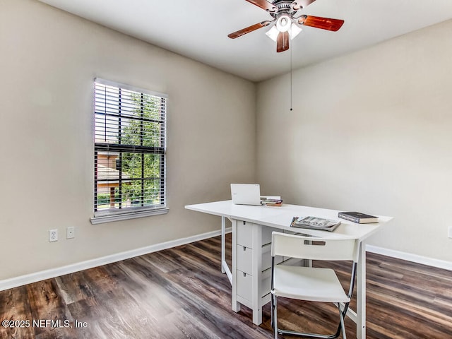 office area with dark wood finished floors, baseboards, and a ceiling fan