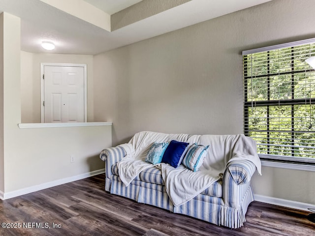 living area with wood finished floors and baseboards