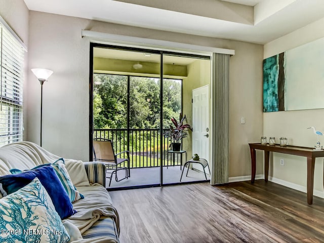 doorway with wood finished floors and baseboards