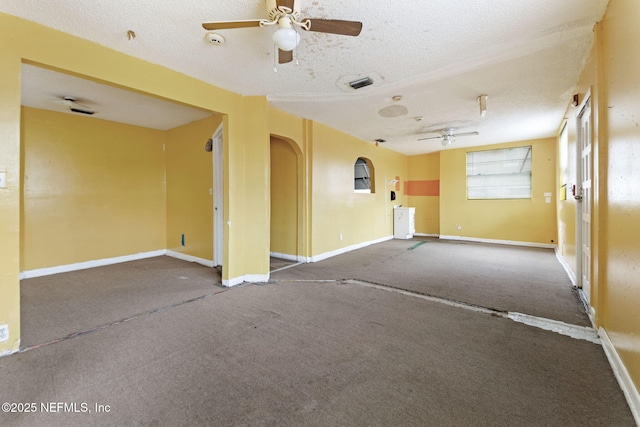 1403 Myrtle Ave N, Jacksonville, FL 32209 - spare room with a ceiling fan, carpet floors, a textured ceiling, arched walkways, and baseboards