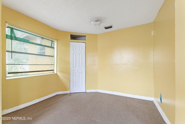 1403 Myrtle Ave N, Jacksonville, FL 32209 - unfurnished bedroom featuring carpet floors, a textured ceiling, baseboards, and a closet