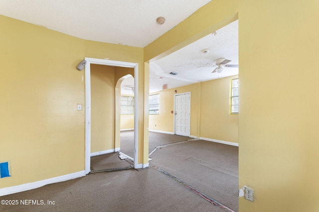 1403 Myrtle Ave N, Jacksonville, FL 32209 - foyer entrance with arched walkways, ceiling fan, baseboards, carpet floors, and a textured ceiling