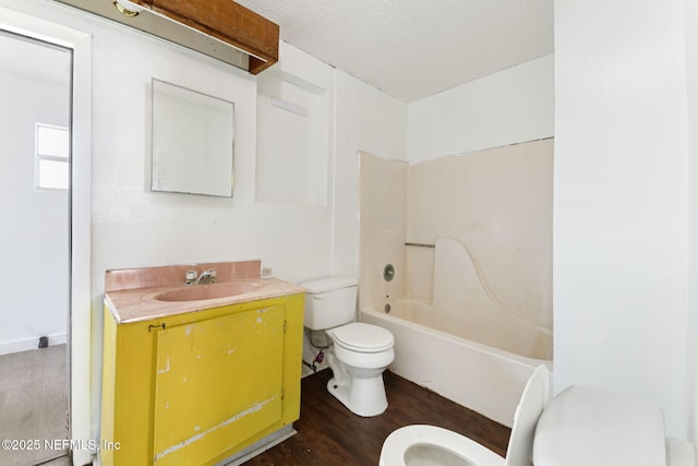 1403 Myrtle Ave N, Jacksonville, FL 32209 - bathroom featuring toilet, wood finished floors, vanity, and a textured ceiling