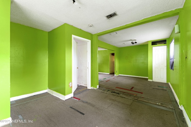 1403 Myrtle Ave N, Jacksonville, FL 32209 - carpeted empty room with a textured ceiling and baseboards
