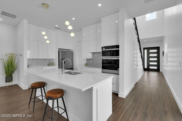 156 Capri Dr, Ormond Beach, FL 32176 - kitchen featuring a sink, refrigerator with ice dispenser, modern cabinets, dark wood-style floors, and recessed lighting