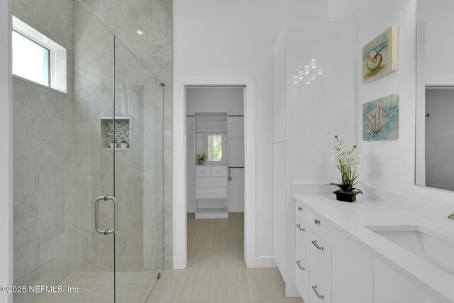 156 Capri Dr, Ormond Beach, FL 32176 - bathroom with a shower stall, vanity, and baseboards