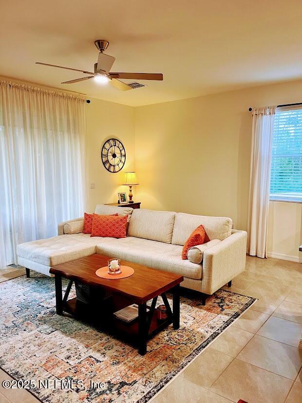 172 Reena Dr, Daytona Beach, FL 32117 - living room featuring light tile patterned floors and ceiling fan